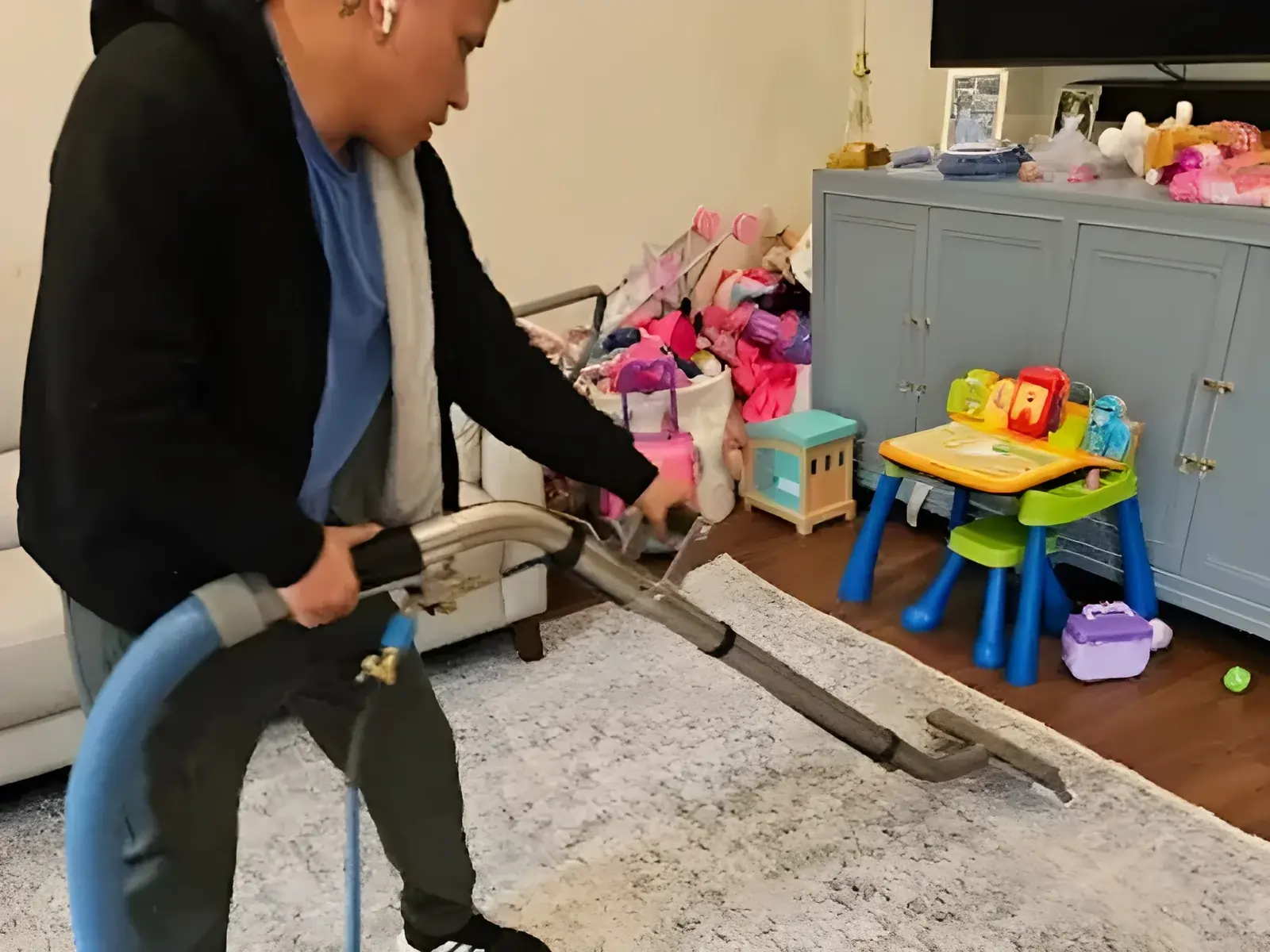 Technician cleaning an area rug in a children's playroom on Long Island